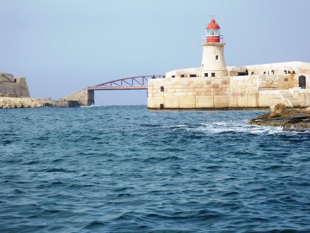 Faro y salida al mar desde el Gran Puerto de La Valetta